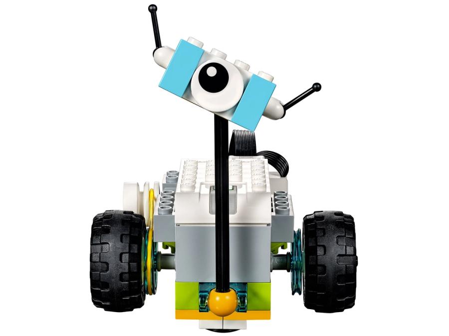 A simple collection of Lego bricks form a cute two wheeled robot with a single eye on a stick.