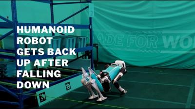 Video of a bipedal robot falling down and then flipping and getting back up.