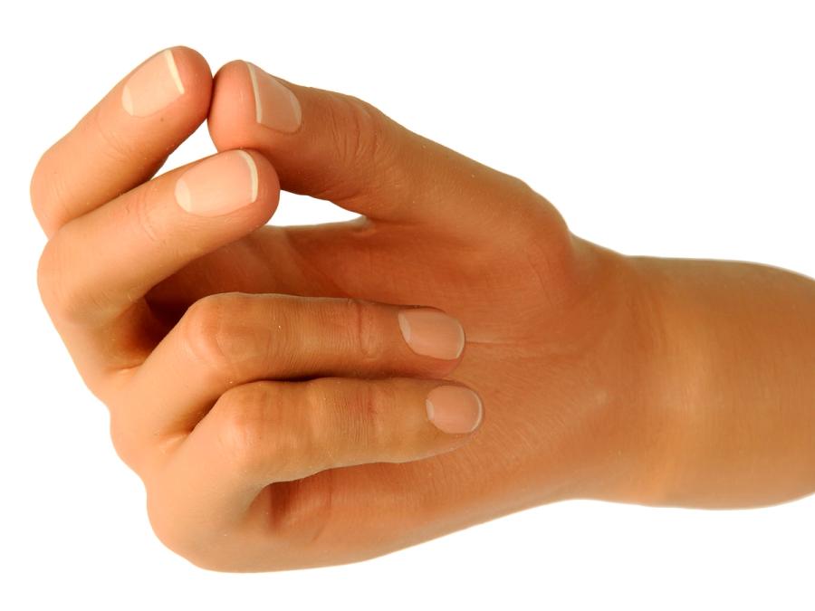 A prosthetic hand is covered by realistic skin with fingernails.