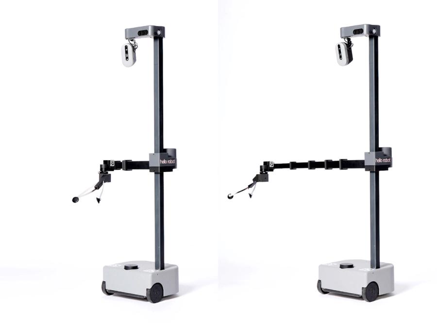 Two mobile robots with a white base supporting a tall black narrow pole with a telescoping arm that can move up or down it. At the top is a small oval with cameras. The robots have different lengths to the telescoping arm.