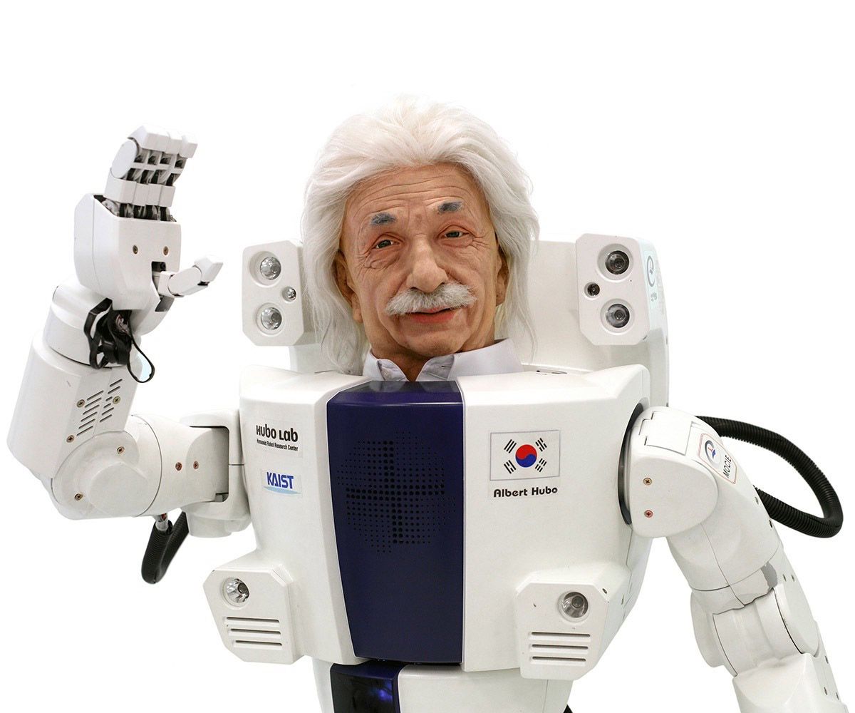 Click through multiple photos to see closer and closer-up photos of a humanoid robot with bushy mustache, eyebrows and hair