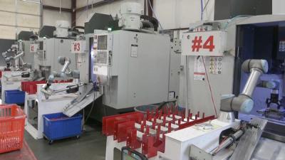 A video showing robots working on CNC machines manufacturing metal parts at Go Fast Campers.